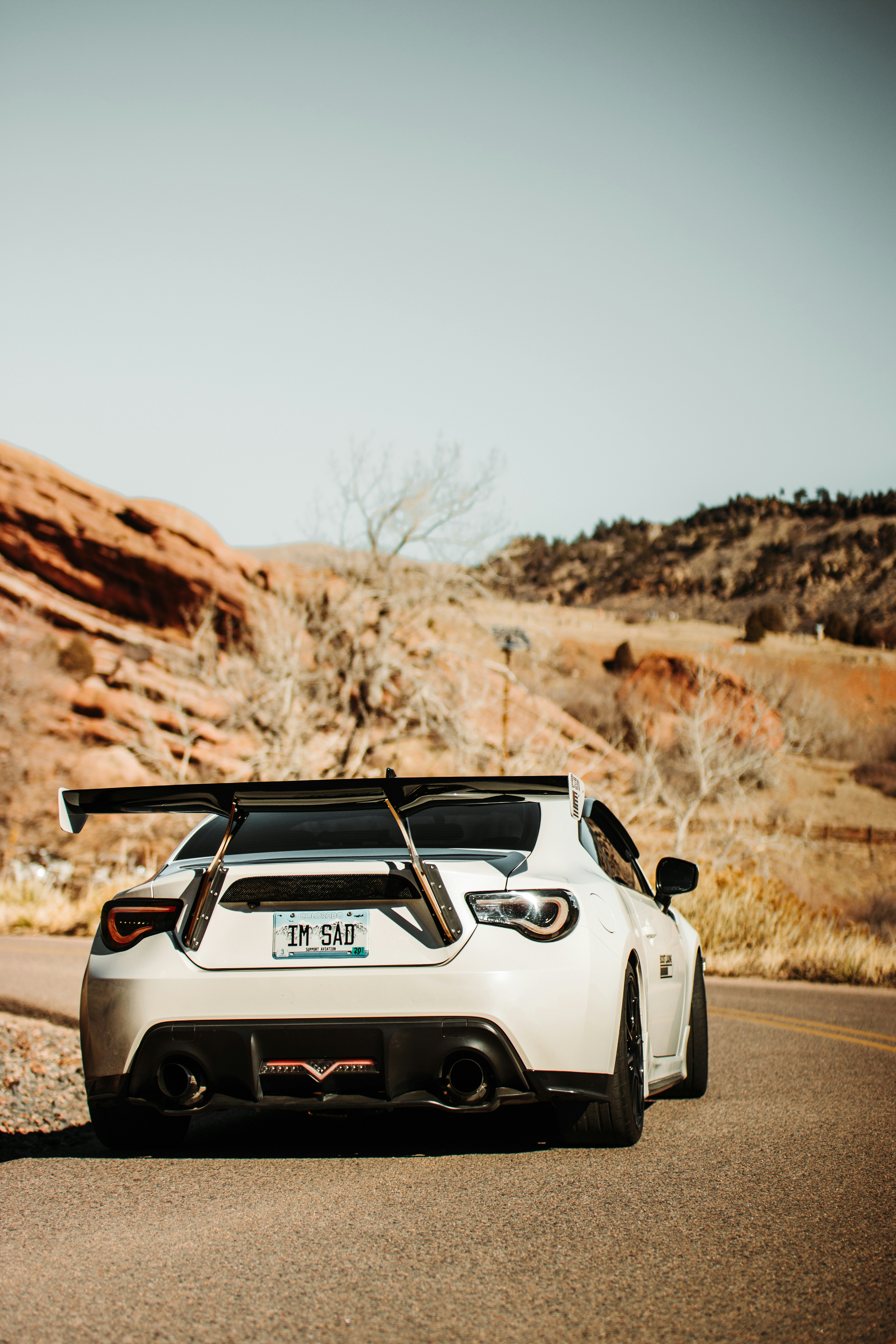 white and black car on brown field during daytime